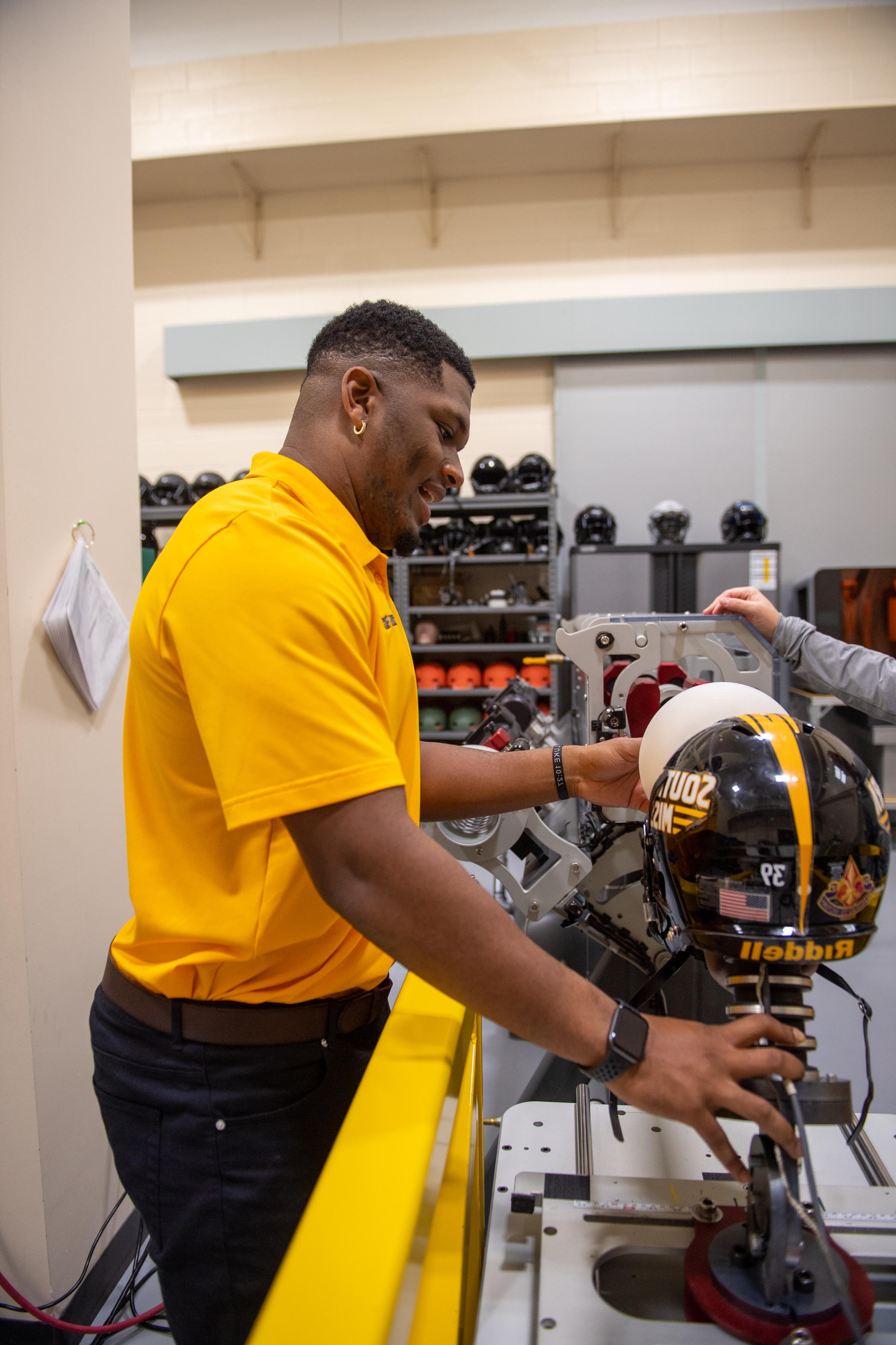 Honors student working on football helmet research